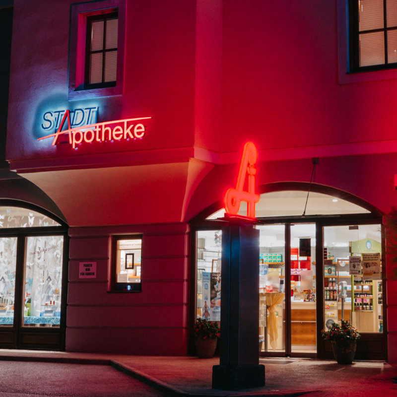 Eingangsbereich der Stadt-Apotheke in der Nacht beleuchtet